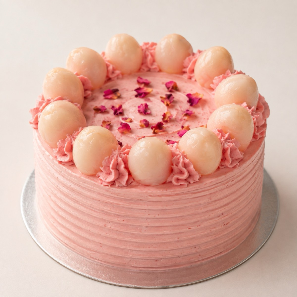 Lychee Rose Cake, a pink cake topped with lychees and rose petals